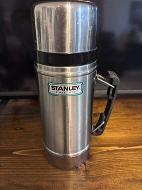 Stanley Stainless Steel Bottle with Black Handle and Green Logo